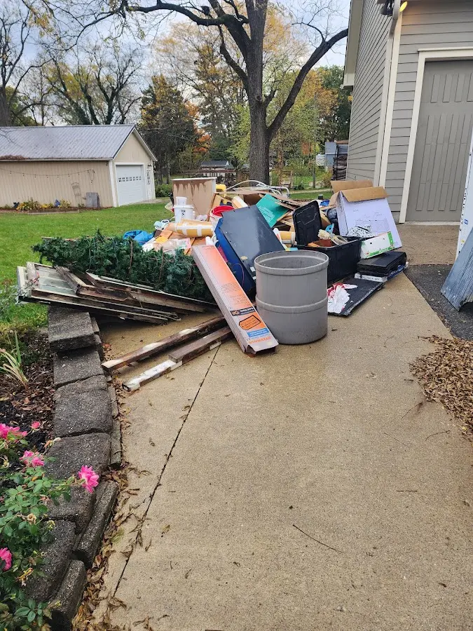 Dumpster being loaded with debris for 12 Yard Dumpster Rental in Toledo